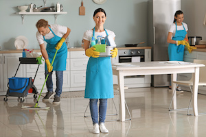 Team of janitors cleaning kitchen